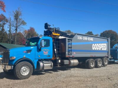 Godspeed Tree Service grapple truck with chipper, ready for storm cleanup and emergency response in Winston-Salem.
